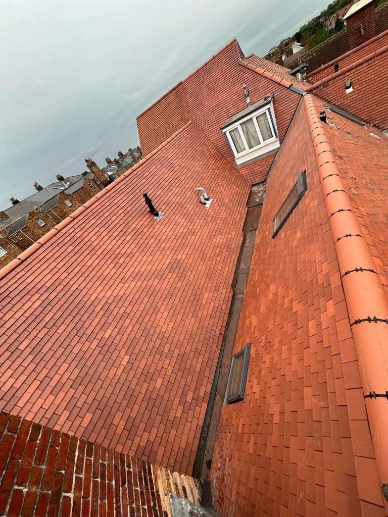 Red tiled roof and dormer seen from the scaffold