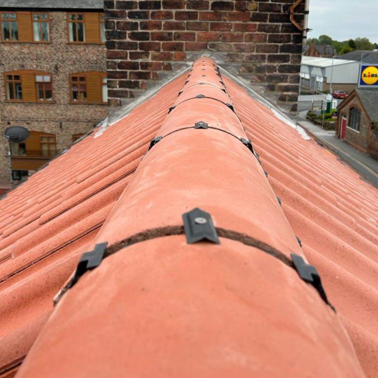 Red dry-fixed ridge with mechanical clips, close up