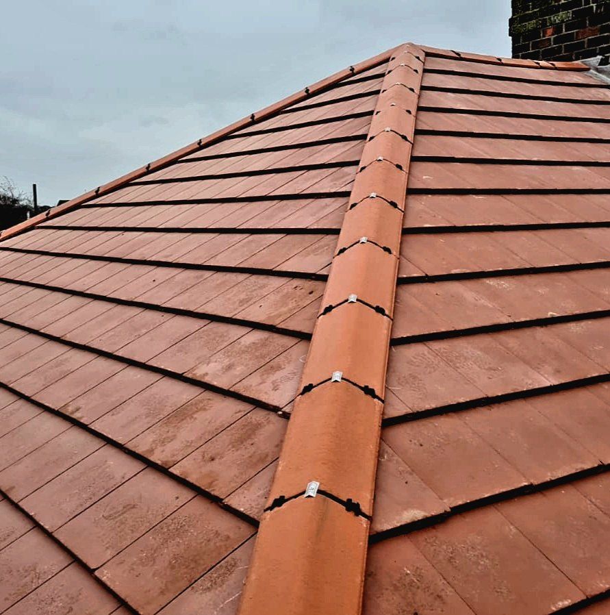 New red plain tiles with a dry-fixed hip