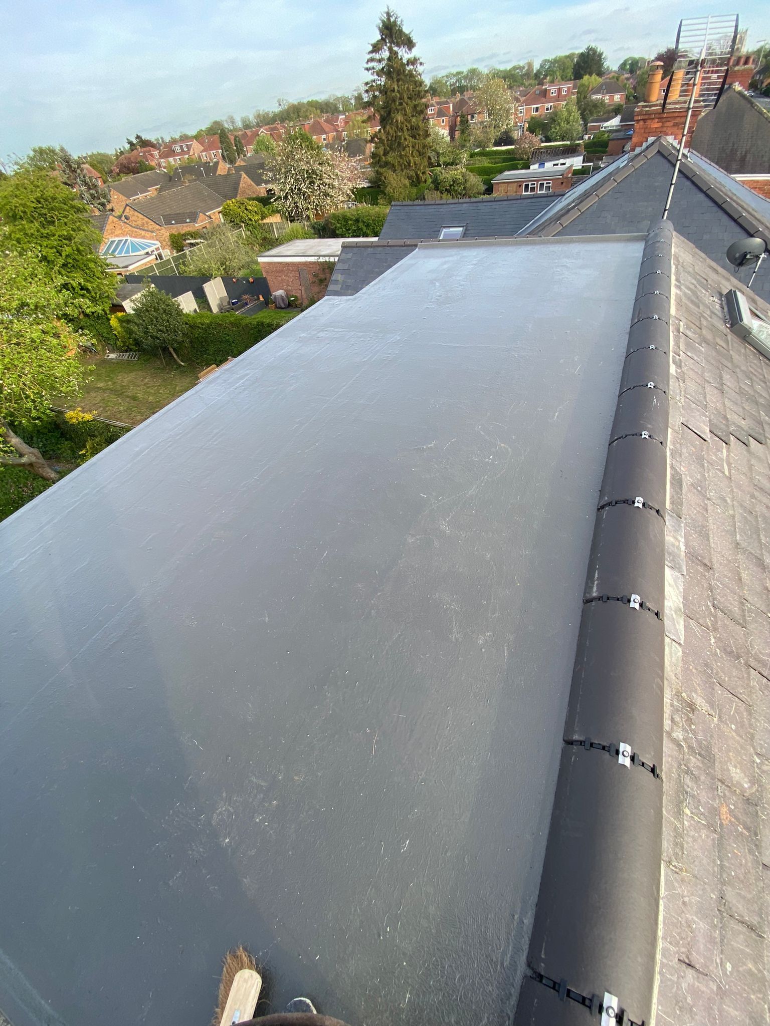 GRP flat roof on top of a dormer, beside a slate roof