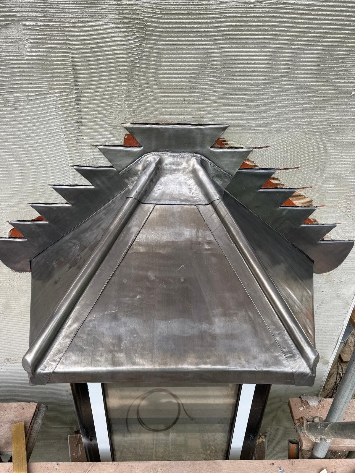 Hand-dressed lead detail at a roof apex