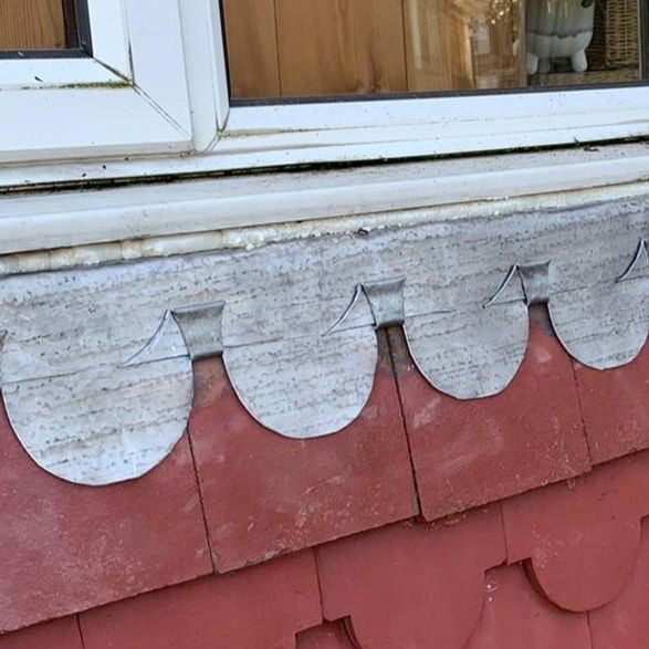 Scalloped lead edging above a bay window
