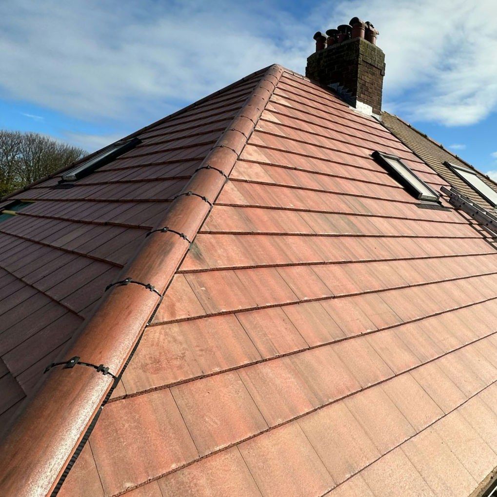 Newly tiled hipped roof with roof windows