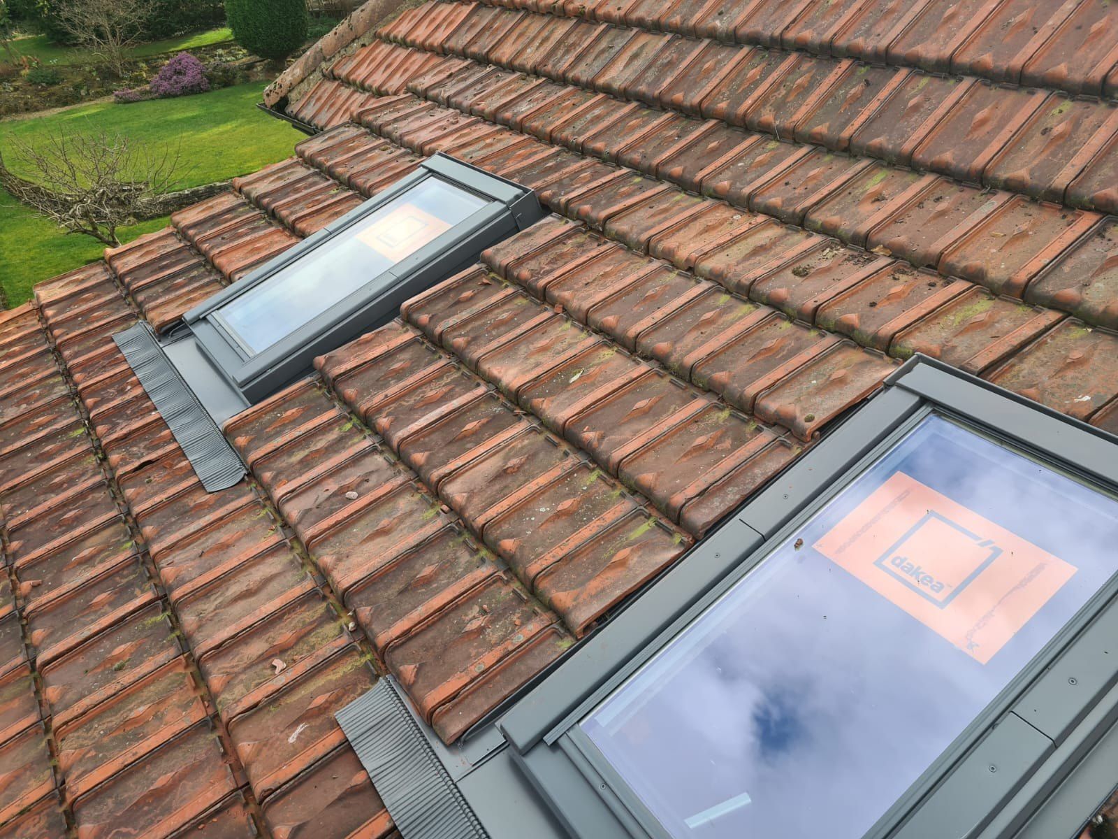 Two roof windows with new flashings in a clay tile roof