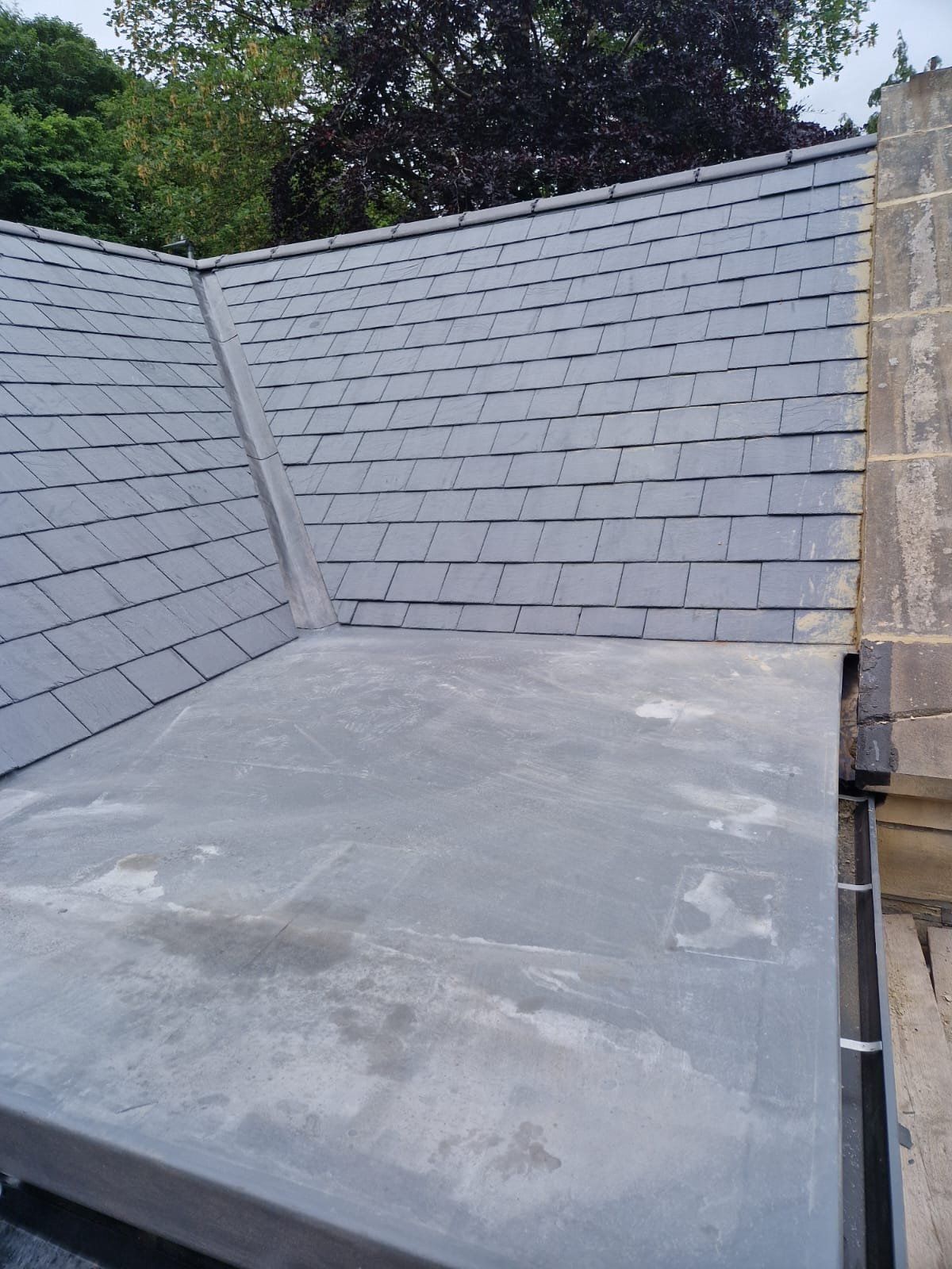 New flat roof beside a slate pitched roof