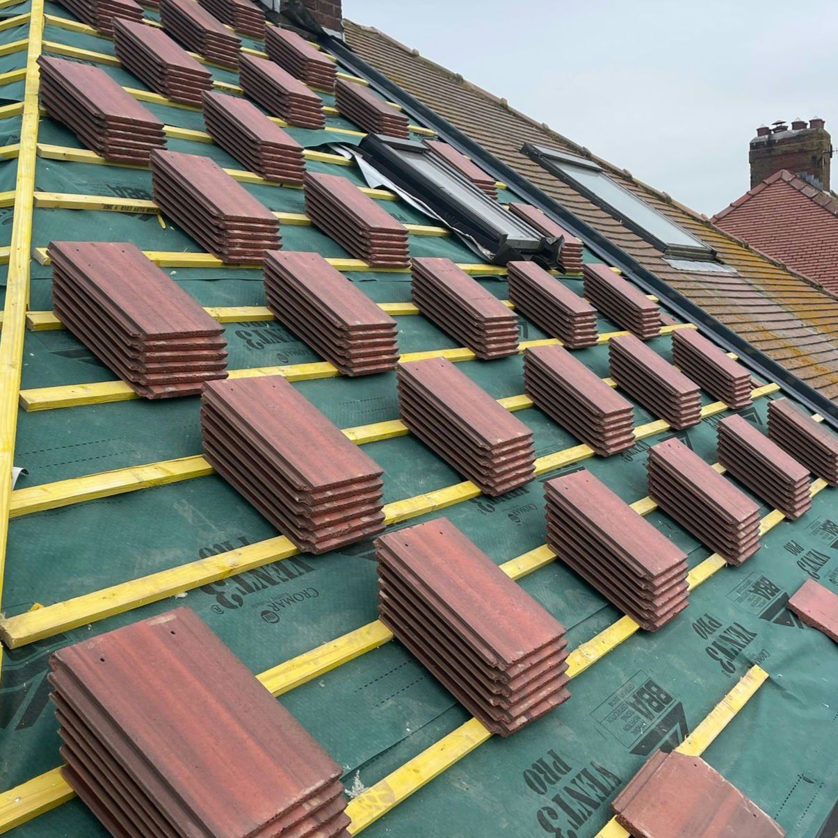 New brindle tiles loaded out on battens over breathable membrane