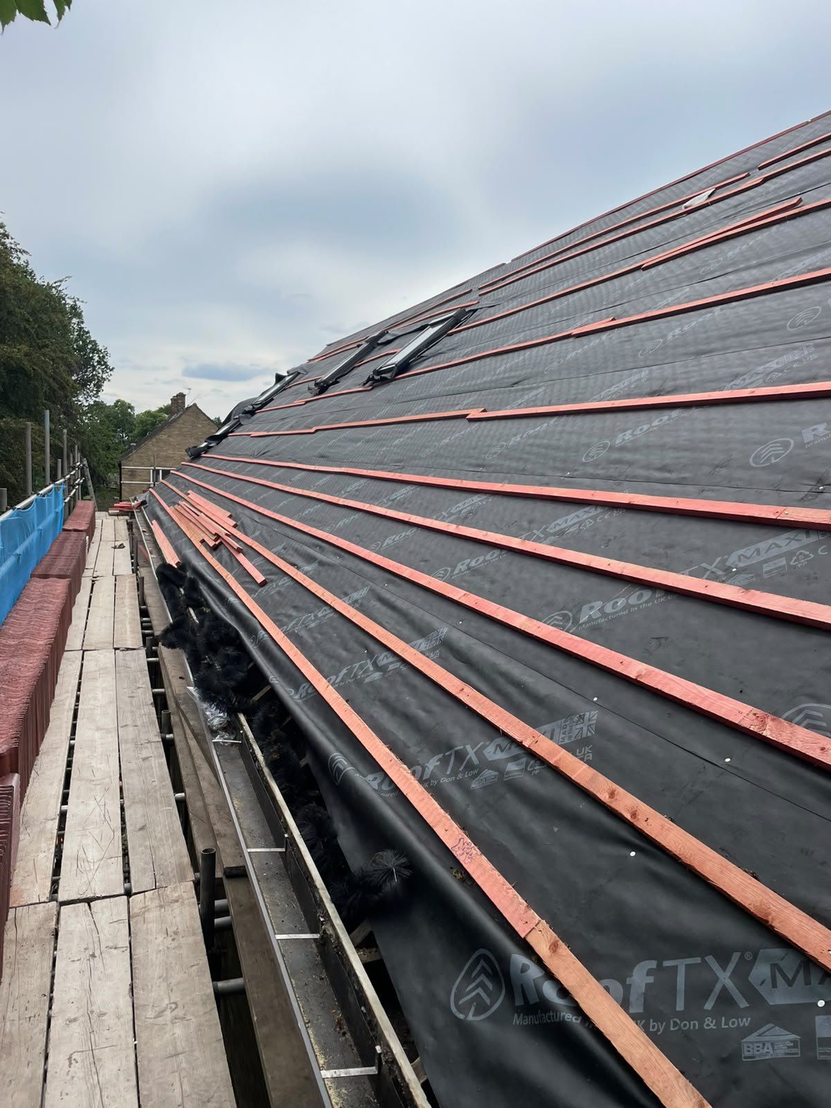 Roof covered in breathable membrane and new battens, ready for tiles