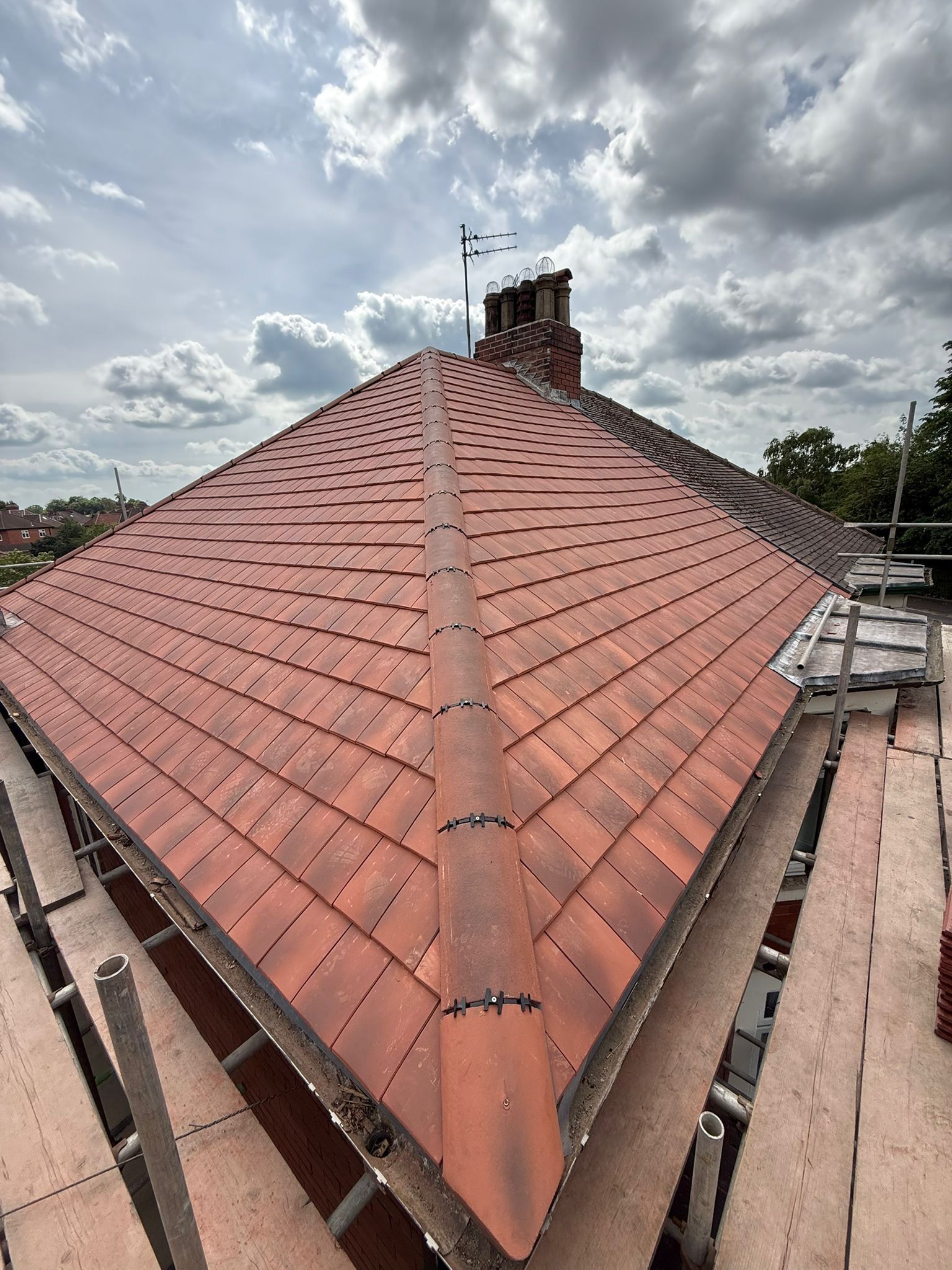 New red hipped roof with clipped ridge and hip tiles
