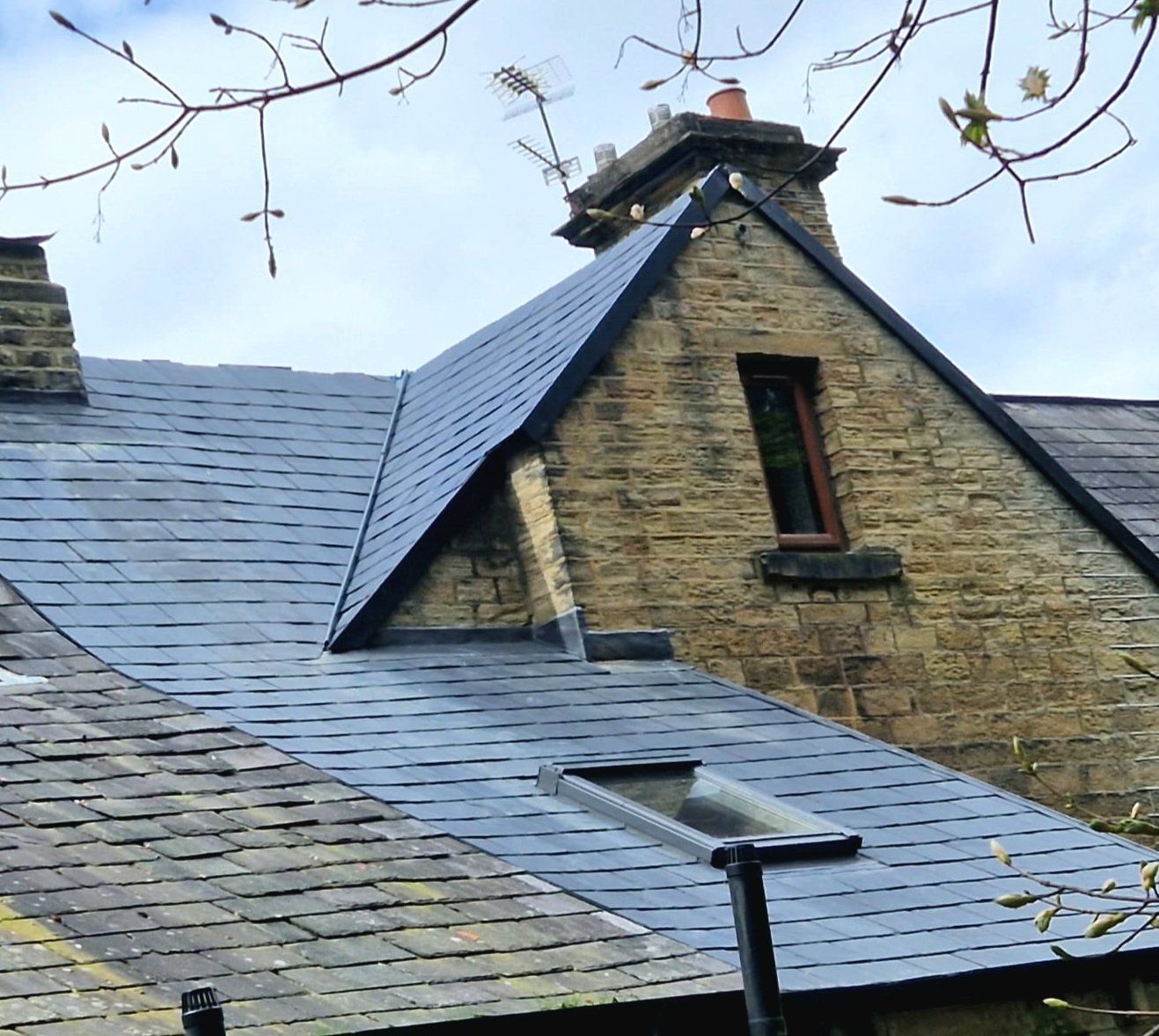 Slate roof on a stone house with new dormer flashings