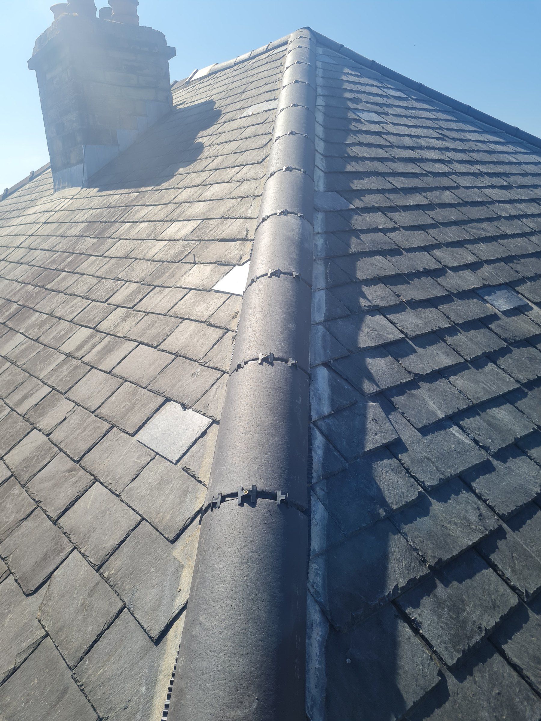 Slate roof with a grey dry-fixed ridge
